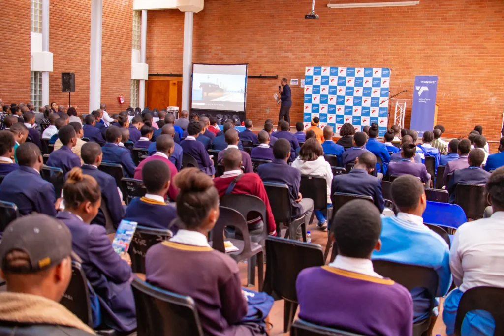 A group of students at a school assembly presented by Transnet