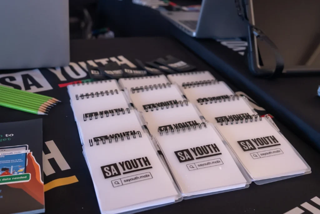closeup of SA Youth branded notepads on a reception table