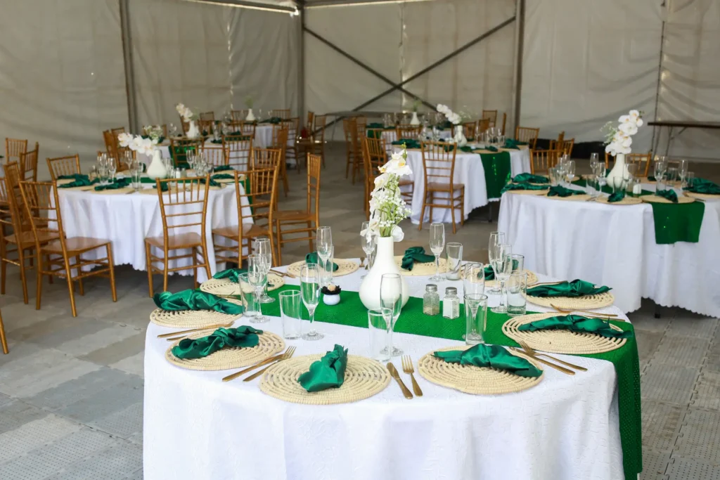 White Dining tables with green decorations spread out in a dining hall