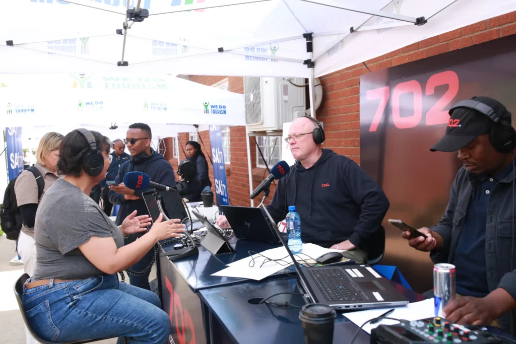 Radio 702 talk show hosts at a pop up booth