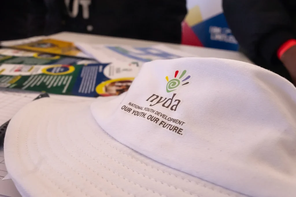 an NYDA branded hat on a booth display table