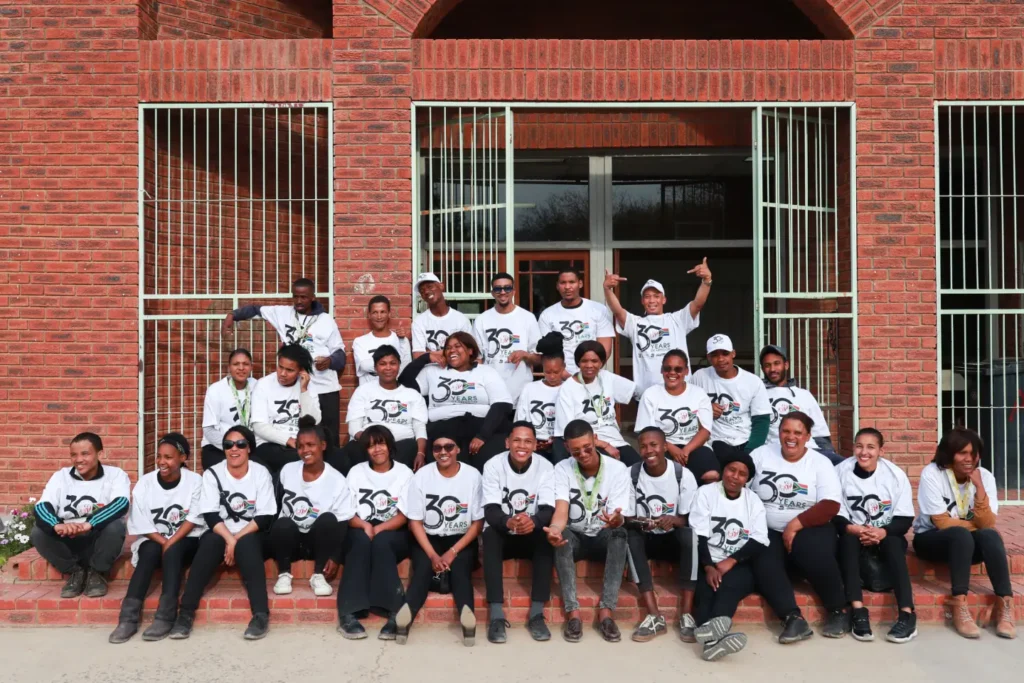 A group photo of all the staff hosting the calvin and fam 30th anniversary event